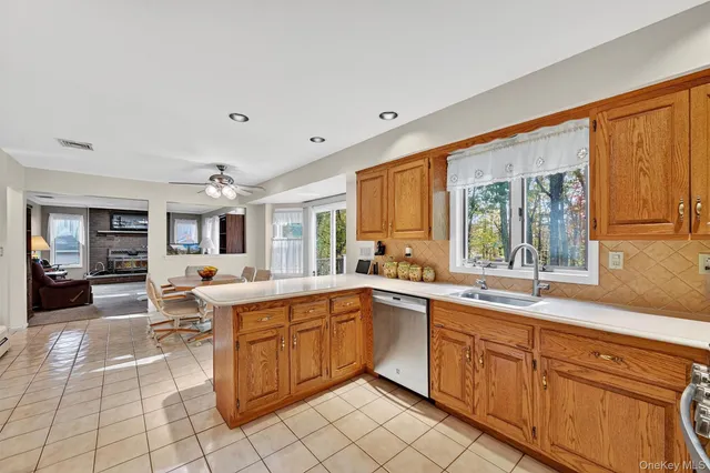 a large white kitchen with a sink and cabinets