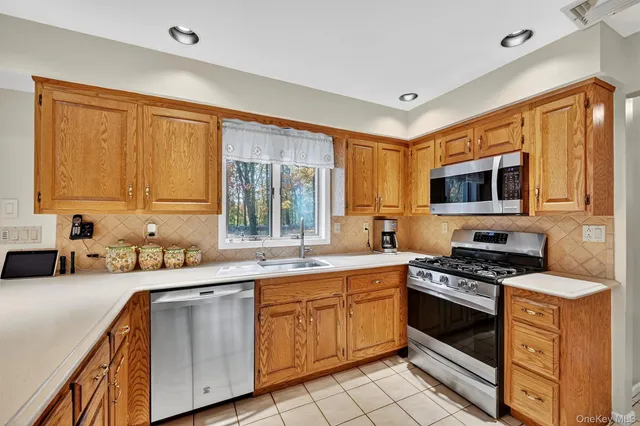 a kitchen with a sink stove top oven and cabinets