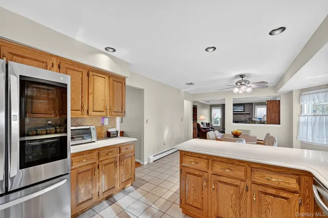 a large white kitchen with stainless steel appliances a stove and a sink