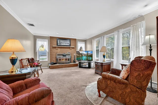 a living room with furniture a large window and a fireplace