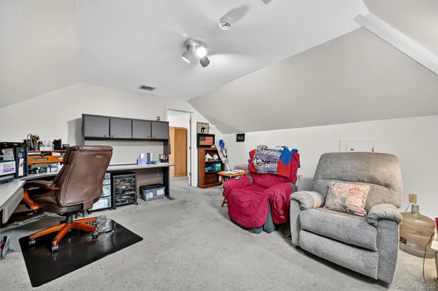 a bedroom with furniture and a flat screen tv