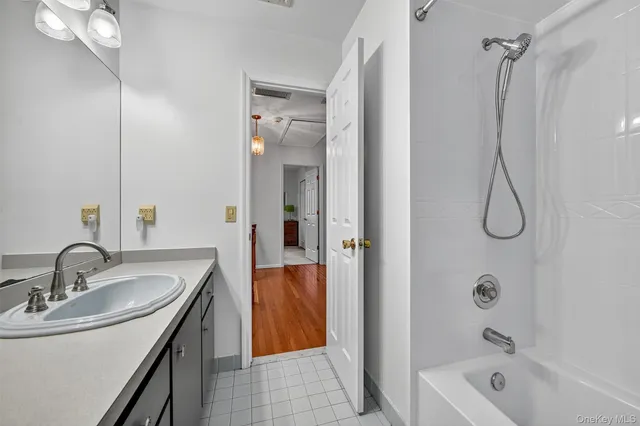 a bathroom with a sink a mirror and a bathtub