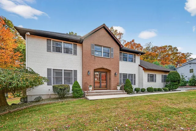 a front view of a house with a garden and plants