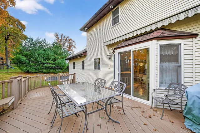 a view of a patio with table and chairs and wooden floor