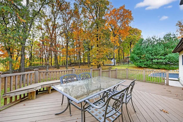 a view of backyard with seating and trees