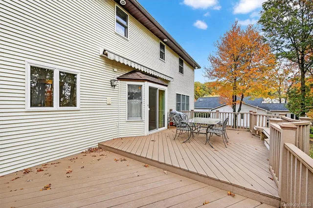 a view of a patio with a table and chairs and wooden floor