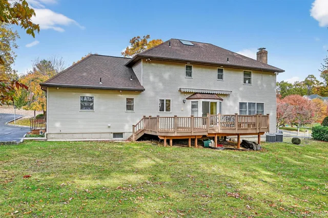 a front view of a house with a garden and deck