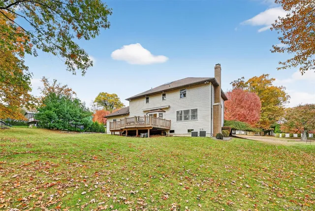 an aerial view of a house with a yard basket ball court and outdoor seating