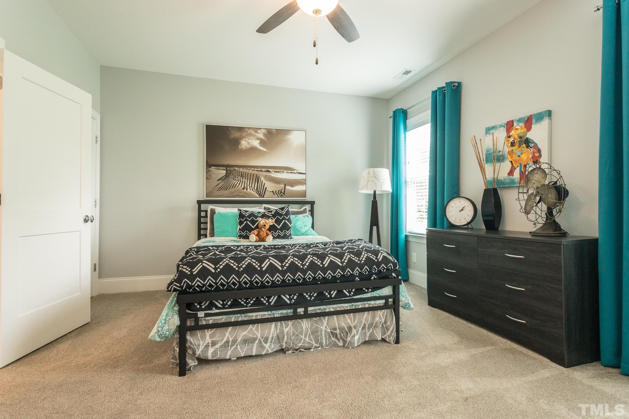 9117 Penny Road Raleigh, NC 27606 - Photo 17 of 54 a bedroom with a bed and a table