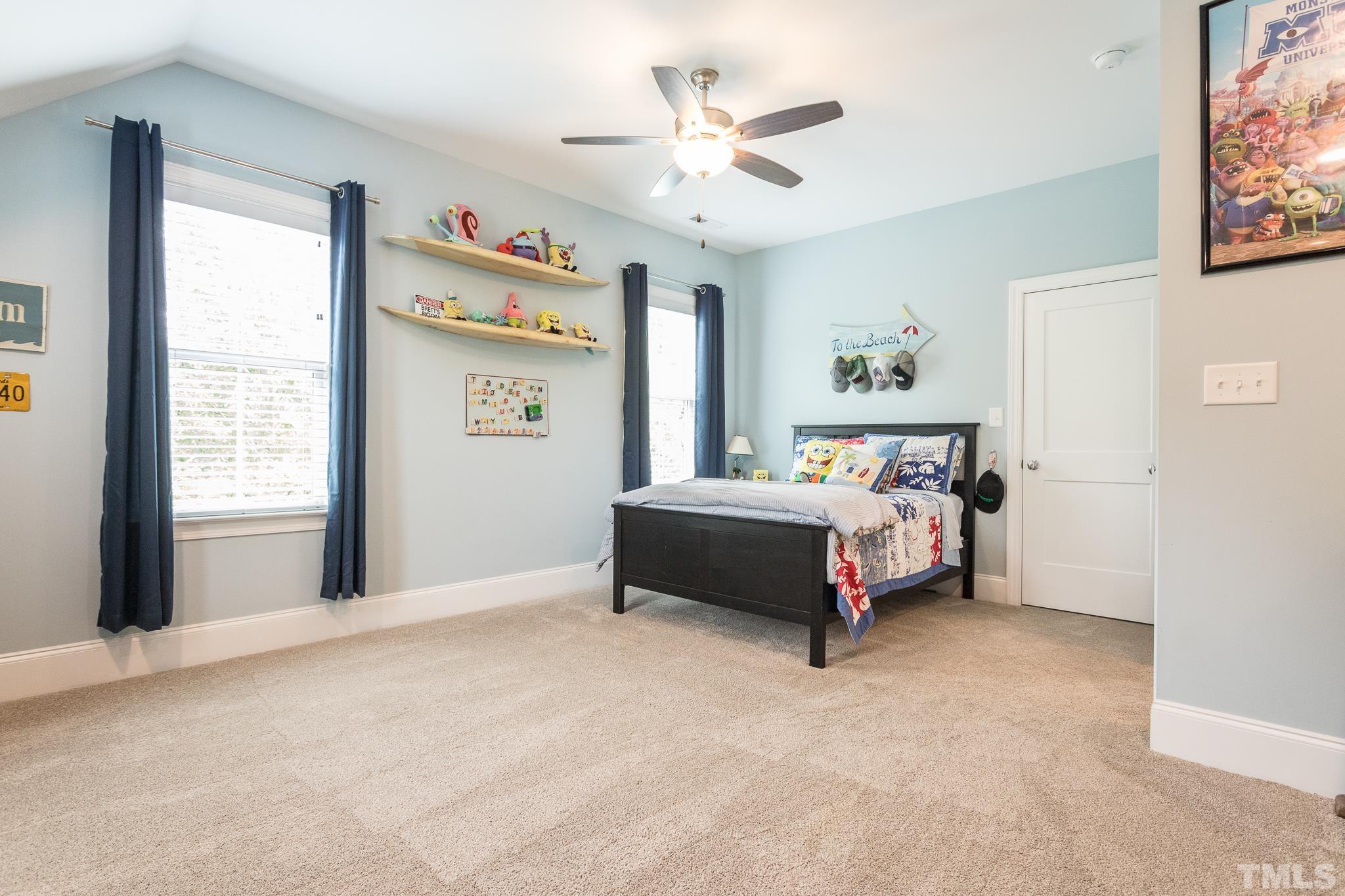 9117 Penny Road Raleigh, NC 27606 - Photo 19 of 54 a bedroom with a bed and a window