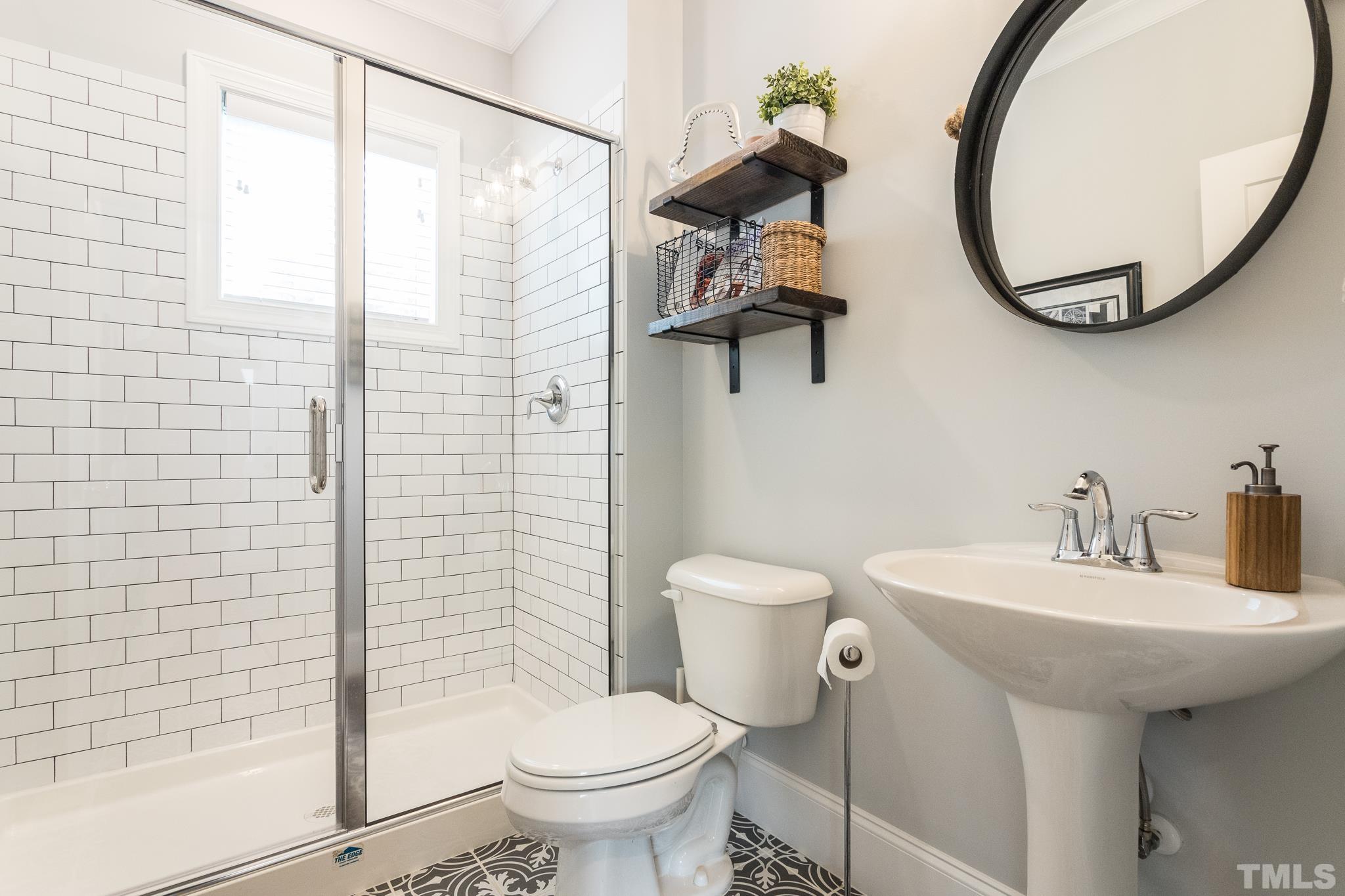 9117 Penny Road Raleigh, NC 27606 - Photo 20 of 54 a bathroom with a sink a toilet and a mirror