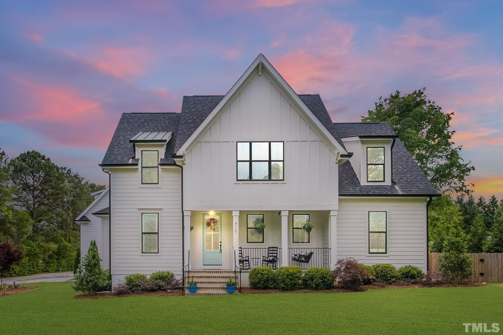 9117 Penny Road Raleigh, NC 27606 - Photo 2 of 54 a front view of a house with a yard and garage