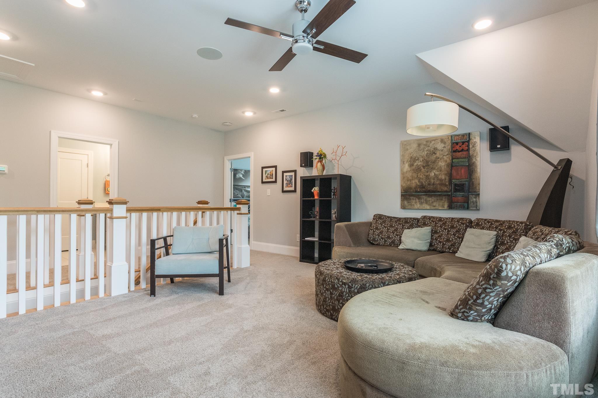 9117 Penny Road Raleigh, NC 27606 - Photo 24 of 54 a living room with furniture and a ceiling fan