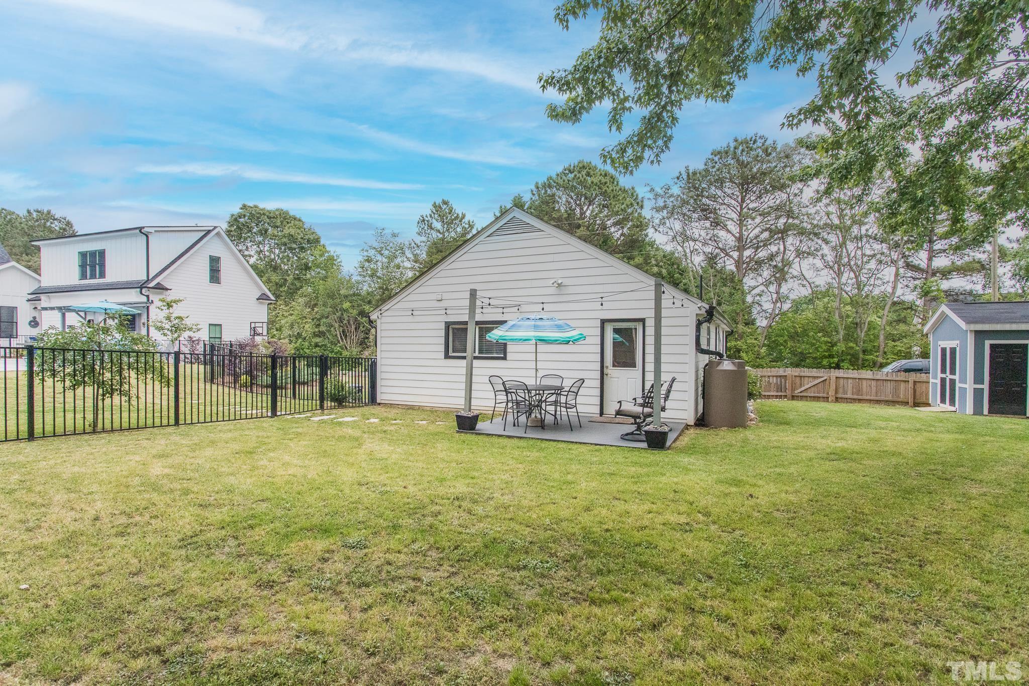 9117 Penny Road Raleigh, NC 27606 - Photo 39 of 54 a view of a house with a yard and sitting area