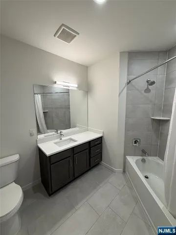 a bathroom with a sink shower and a mirror