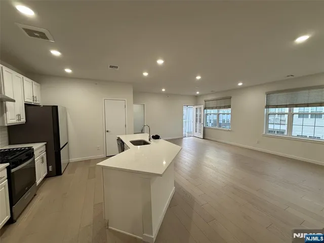 a view of an empty room and wooden floor