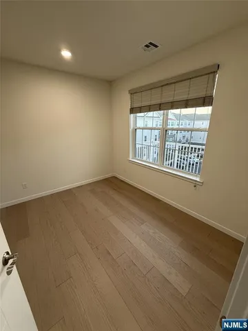 a view of a hallway with wooden shelves