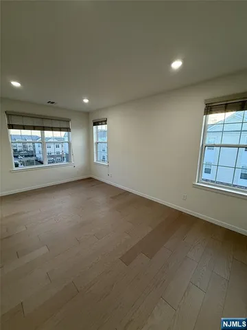 a kitchen with a sink stainless steel appliances and white cabinets