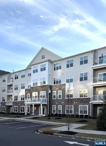 a kitchen with a refrigerator and a stove top oven