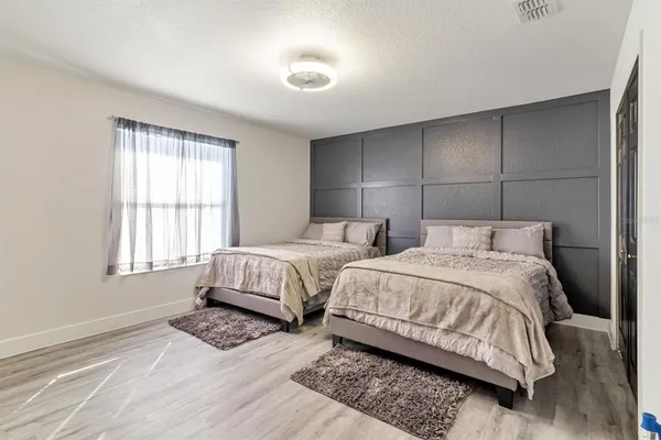 a bedroom with two beds and a window