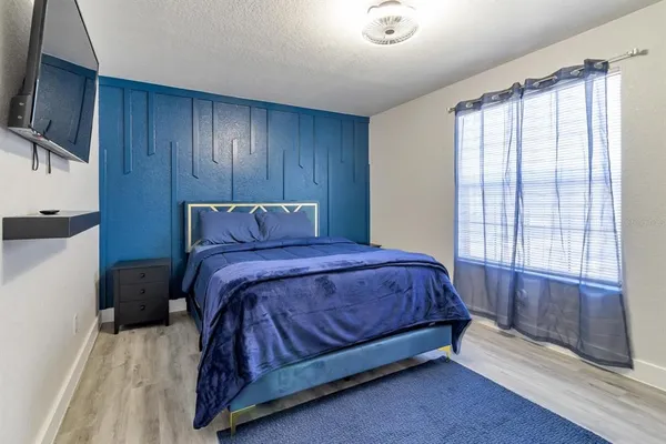 a bedroom with a bed and window