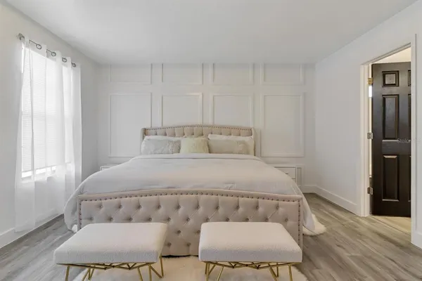 a bedroom with a bed and window