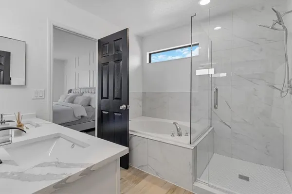 a bathroom with a sink a toilet and shower