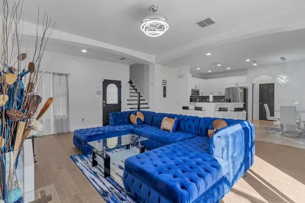 a living room with furniture and a chandelier
