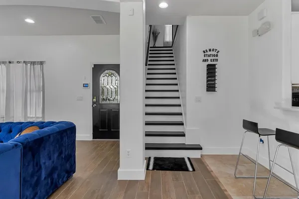a view of entryway and hall with wooden floor