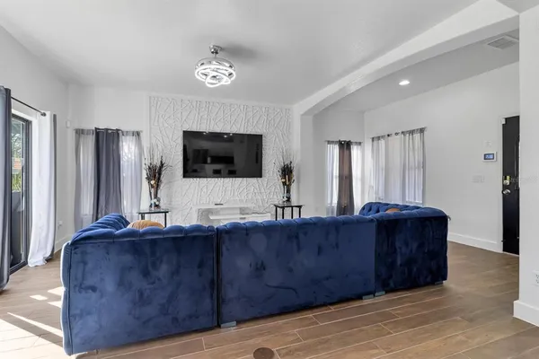 a living room with hard wood floors and furniture