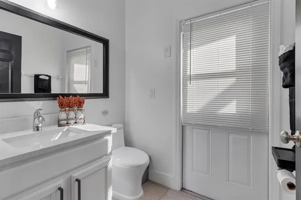 a bathroom with a toilet a sink and a mirror