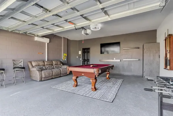 a living room with furniture a rug and white walls