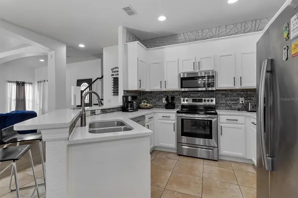a kitchen with a sink appliances and cabinets