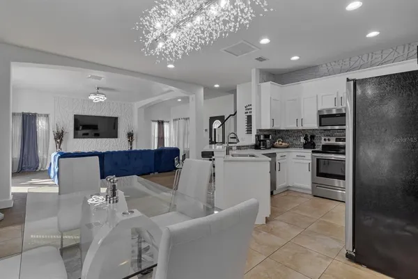 a kitchen with white cabinets and stainless steel appliances