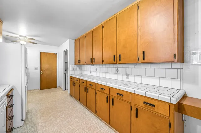 a kitchen with stainless steel appliances granite countertop a sink and a stove