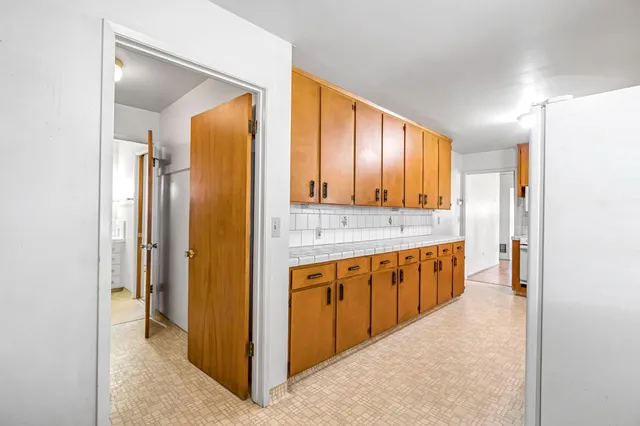 a large bathroom with a granite countertop double vanity sink and a mirror