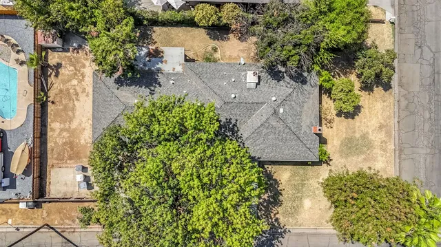 an aerial view of a house with a yard and garden