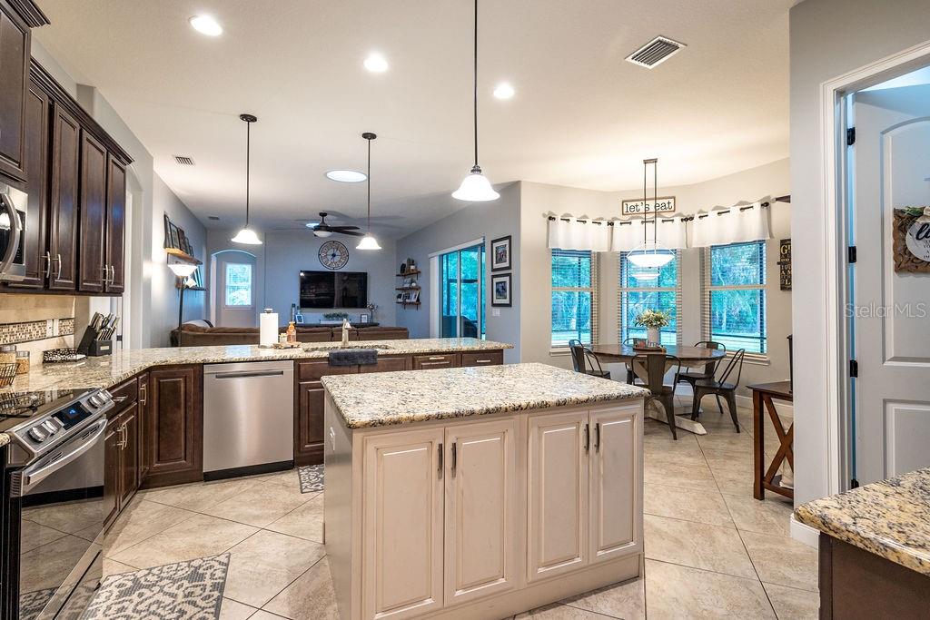 316 Old Mill Road Deltona, FL 32725 - Photo 12 of 64 a kitchen with kitchen island granite countertop lots of counter top space and stainless steel appliances