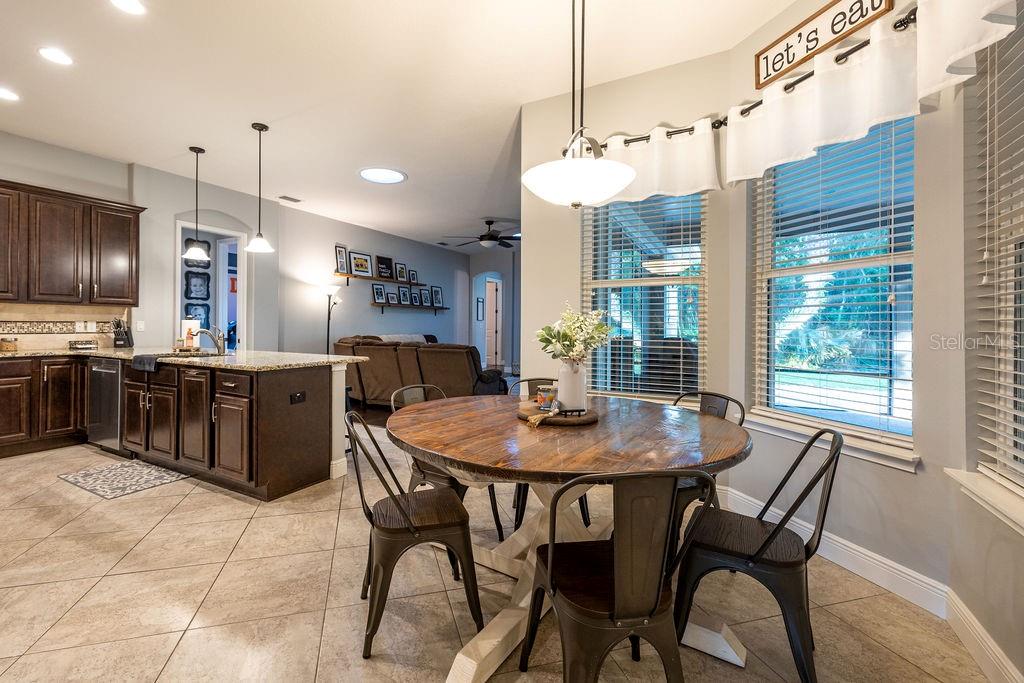 316 Old Mill Road Deltona, FL 32725 - Photo 14 of 64 a kitchen with a dining table chairs and stainless steel appliances