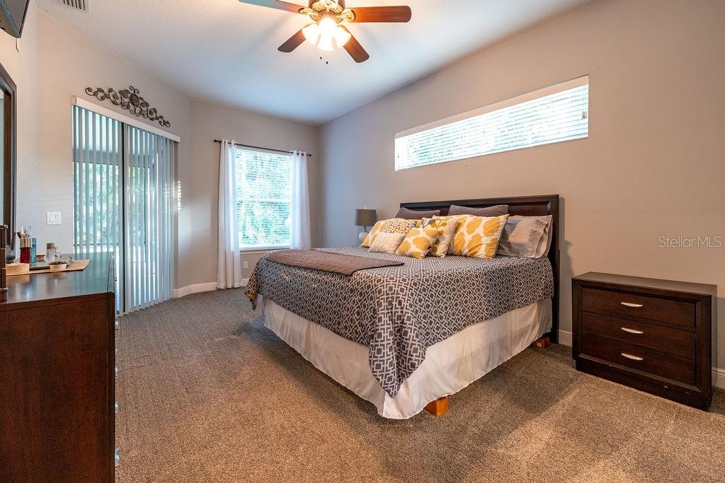 316 Old Mill Road Deltona, FL 32725 - Photo 18 of 64 a bedroom with a bed and a dresser