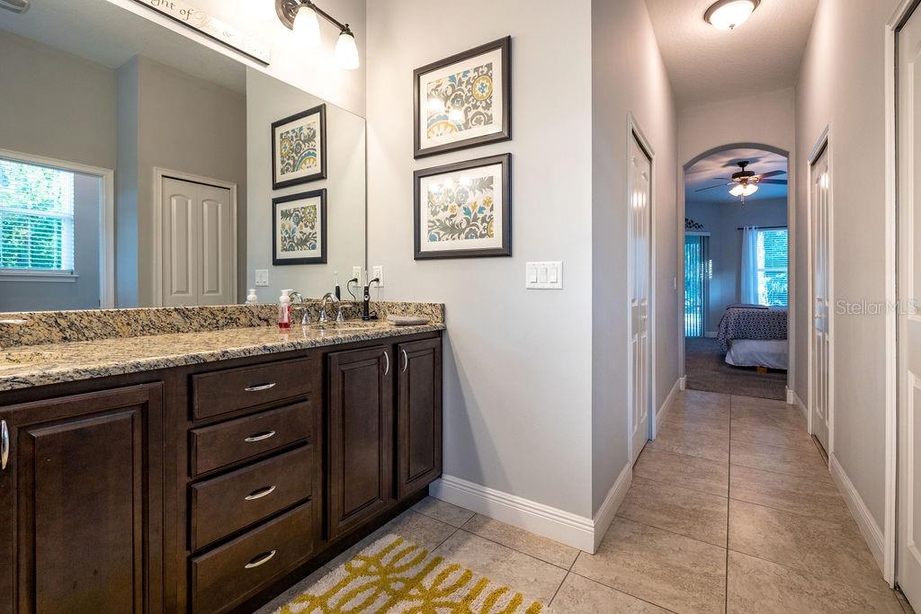 316 Old Mill Road Deltona, FL 32725 - Photo 21 of 64 a bathroom with a granite countertop sink a mirror and a vanity