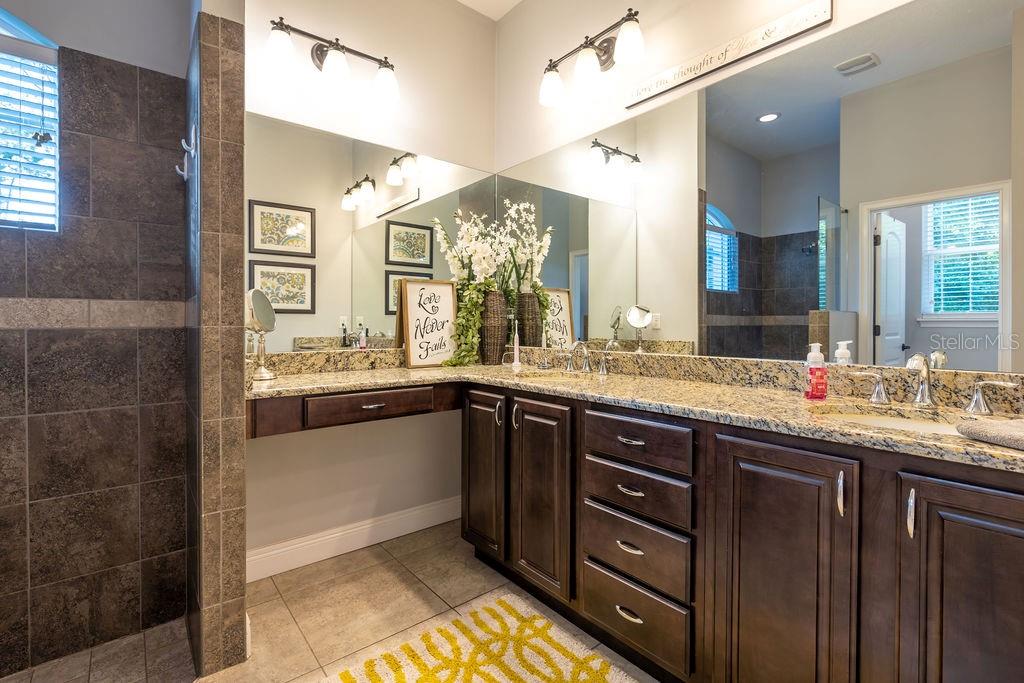 316 Old Mill Road Deltona, FL 32725 - Photo 22 of 64 a bathroom with a double vanity sink and a mirror