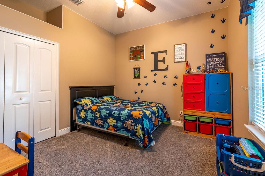 316 Old Mill Road Deltona, FL 32725 - Photo 24 of 64 a bedroom with a bed and a chandelier