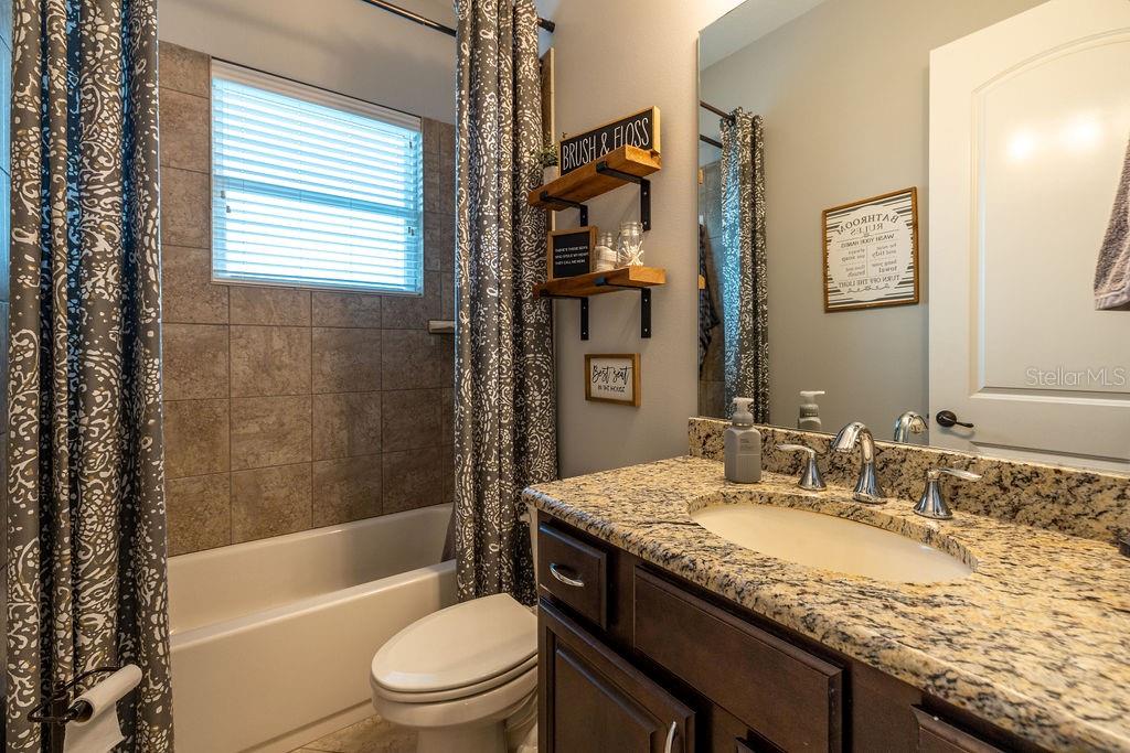 316 Old Mill Road Deltona, FL 32725 - Photo 25 of 64 a bathroom with a granite countertop sink toilet and shower