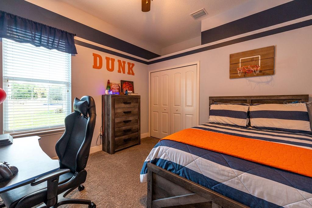 316 Old Mill Road Deltona, FL 32725 - Photo 27 of 64 a bedroom with furniture and a window