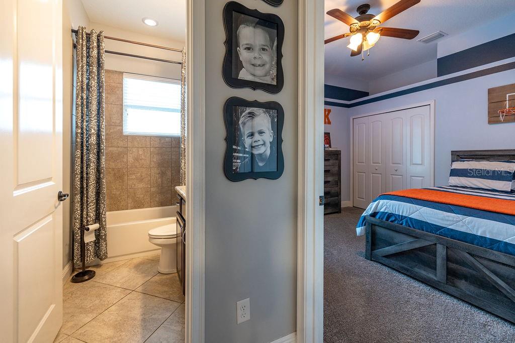 316 Old Mill Road Deltona, FL 32725 - Photo 28 of 64 a bathroom with a toilet a sink and glass door