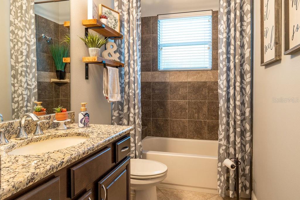 316 Old Mill Road Deltona, FL 32725 - Photo 29 of 64 a bathroom with a granite countertop sink toilet and shower