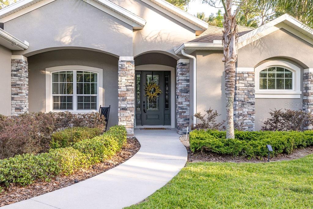 316 Old Mill Road Deltona, FL 32725 - Photo 3 of 64 a front view of a house with garden
