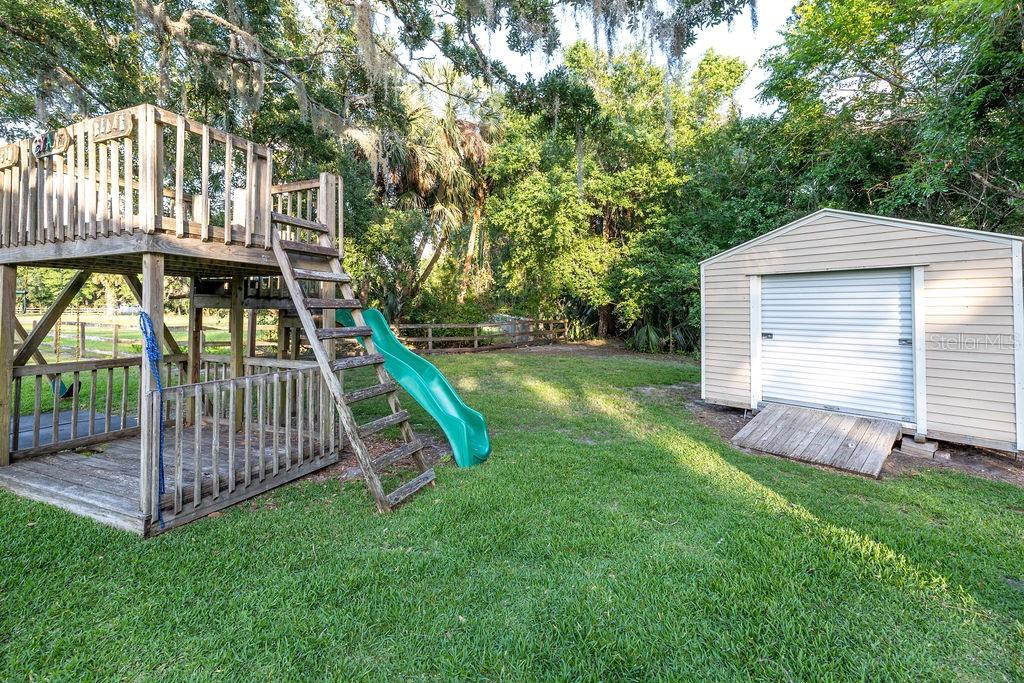 316 Old Mill Road Deltona, FL 32725 - Photo 35 of 64 a view of a house with a yard and deck