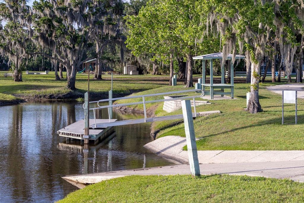 316 Old Mill Road Deltona, FL 32725 - Photo 50 of 64 a view of a swimming pool with a patio and a yard